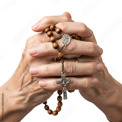 Closeup of elderly hands holding a wooden rosary with a crucifix while praying, isolated on transparent background