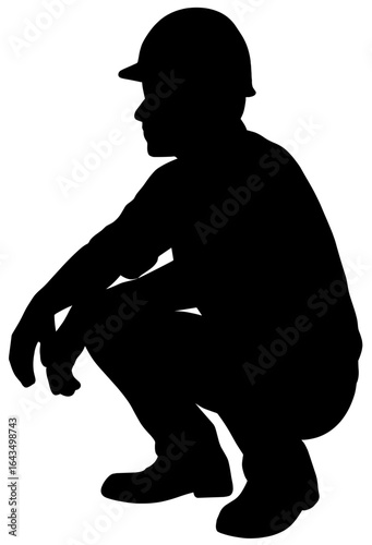 Silhouette of Construction Worker Squatting with Safety Helmet