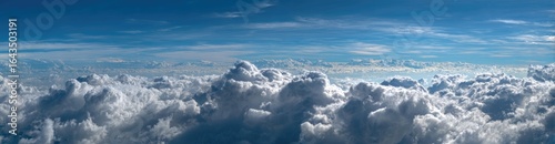 Panoramic view of puffy white clouds against a bright blue sky