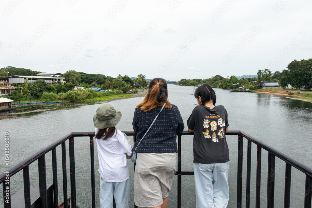 Fototapeta premium Family Touring Bridge Over River Kwai, Thailand