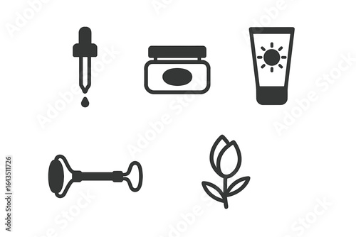 Various skincare tools and products displayed on a neutral background for personal care routines and beauty applications