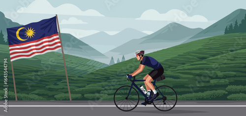 A cyclist rides along a scenic mountain road with the Malaysian flag displayed on the roadside.
