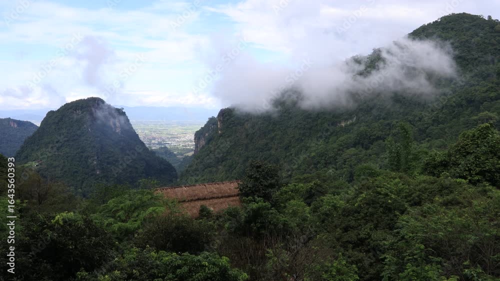 Close-up nature video of the atmosphere surrounded by mountains, grasslands, mist from rain and heat that causes fog to cover the area. The joy of traveling and experiencing nature. Close-up nature video of the atmosphere surrounded by mountains, grasslands, mist from rain and heat that causes fog to cover the area. The joy of traveling and experiencing nature.
