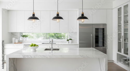 A sleek modern white kitchen interior featuring a marble countertop island under stylish black pendant lights.