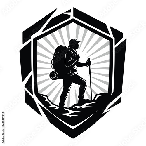 Silhouette of a hiker with a backpack and trekking poles on a mountain peak