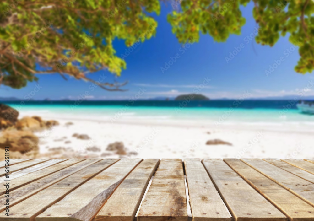 Fototapeta premium Wooden table top on the beach or sea.Party on the beach sunshine time concept.For montage product display or design key visual layout.View of copy space.