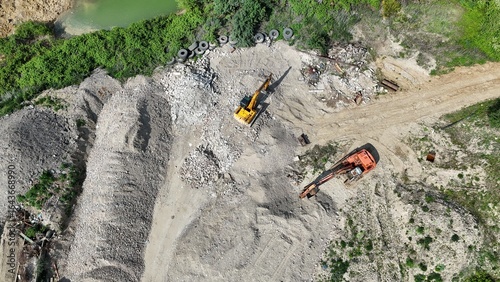 Excavator , diggers Overhead birds eye drone aerial view  in quarry Essex UK