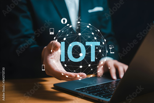 Man holds glowing IoT network globe connecting devices and data for futuristic business