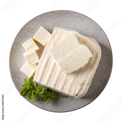 Brynza cheese isolated on white background. Soft sheep's cheese bryndza on gray plate. Top view.
