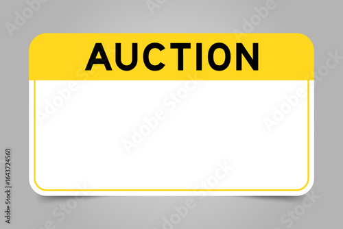 Label banner that have yellow headline with word auction and white copy space, on gray background