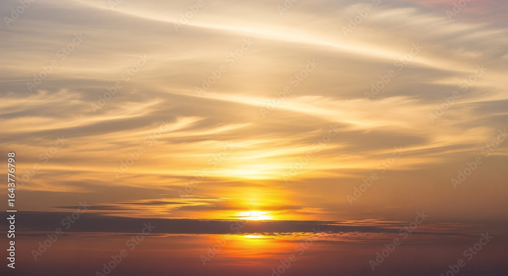 Fototapeta premium Dramatic Golden Hour Cloudy Sky Landscape in a Warm Natural Setting