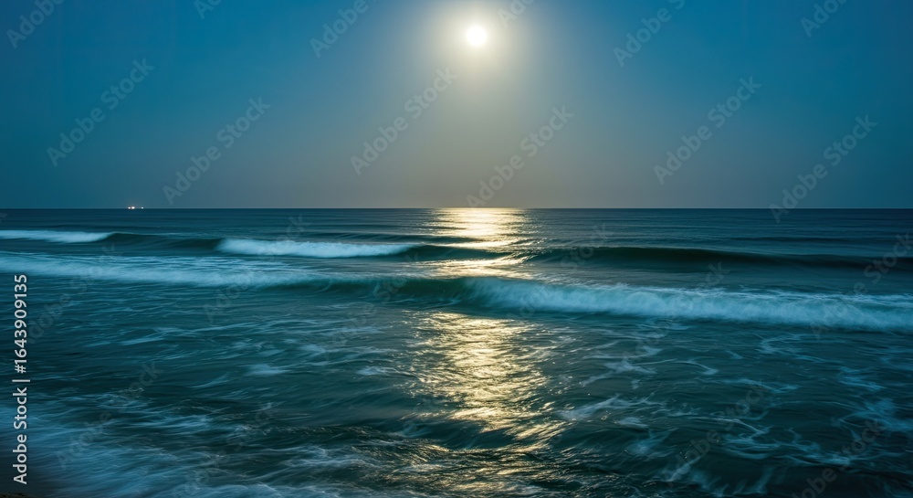 Obraz premium Serene Ocean Waves Under a Luminous Full Moon and Reflective Moonlight Path