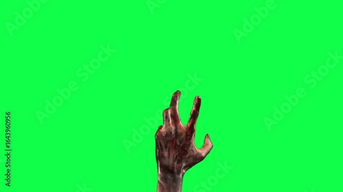 Zombie hand reaching out on green screen for compositing and special effects