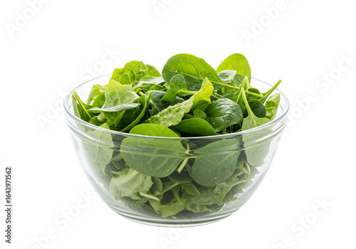 Fresh green spinach in glass bowl raw salad ingredient isolated