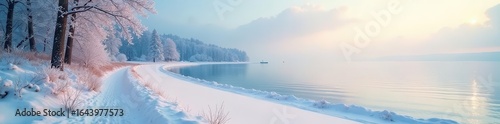 A serene winter landscape featuring a snow covered path beside a tranquil lake with distant trees under a soft sky