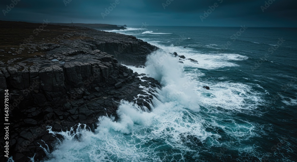 Fototapeta premium Tempestuous Ocean Waves Crash Against Jagged Black Cliffs Under a Dark, Moody Sky.