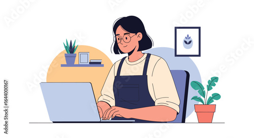 Young woman in glasses and apron happily typing on laptop computer at desk with plants