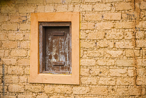 adobe brick wall with rustic window