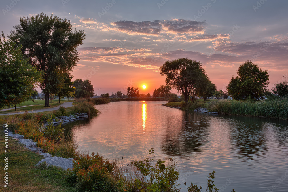 Obraz premium captivating summer sunsets and sunrises create enchanting atmosphere over tranquil lake