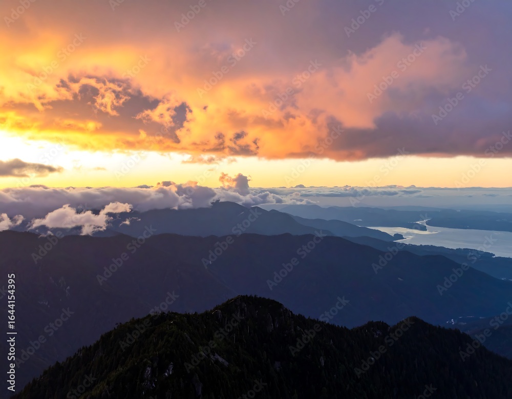 Obraz premium Mountain sunrise, vibrant clouds, valley below