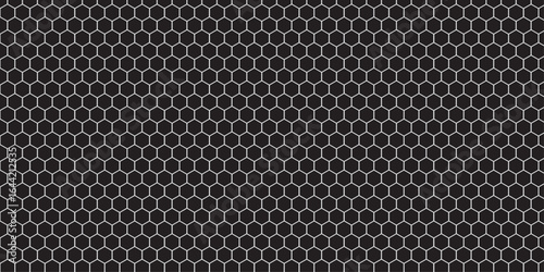 Dark carbon fiber texture with a metallic mesh pattern and seamless grid of holes, perfect for an industrial technology background