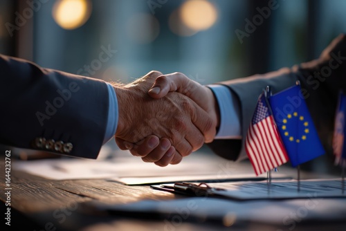 Handshake with Flags: Two figures clasp hands in a gesture of unity and partnership, symbolizing collaboration with the flags of USA and EU in the frame.