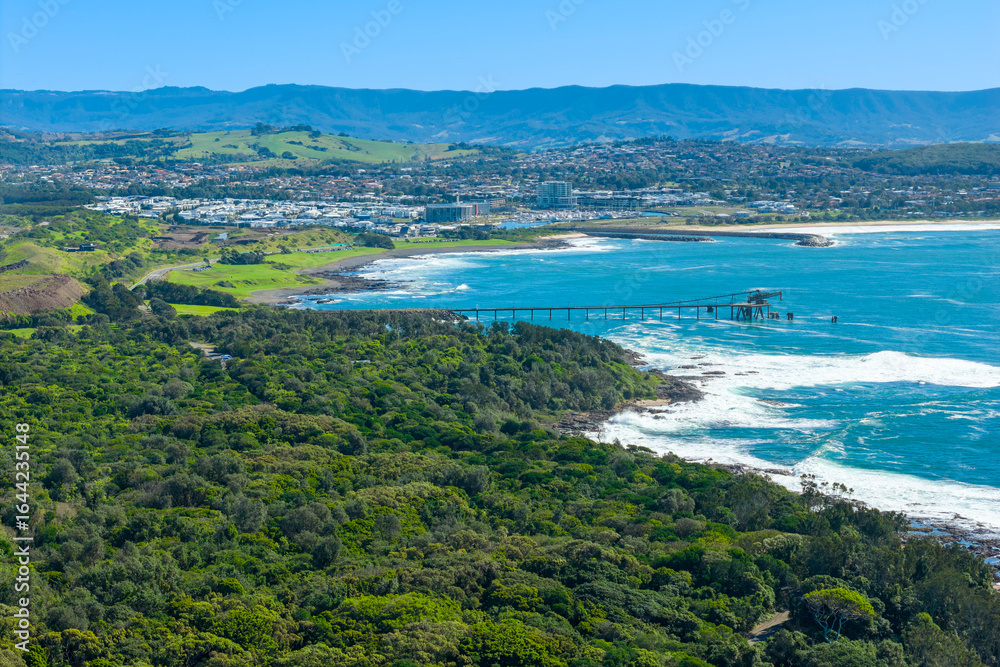 Obraz premium Drone aerial photograph of an old and weathered industrial loading jetty in the South Pacific Ocean near Shellharbour in the Illawarra region on the south coast of New South Wales, Australia.
