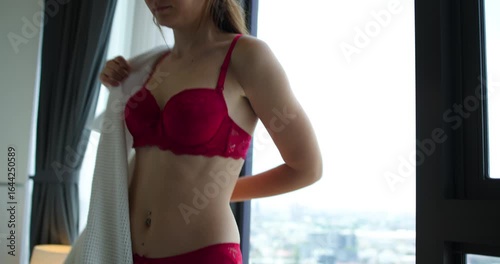 Joyful Living lifestyle of Young woman in bed room, woman with red lace bra lazy stretched and yawned drowsy after waking up