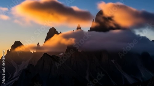 Dramatic Dolomites Peaks Engulfed in Golden Sunset Clouds, Italy