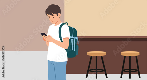 Student checking smartphone in cafe. Young man with backpack uses mobile phone app. College student messaging friends or checking social media updates inside coffee shop.