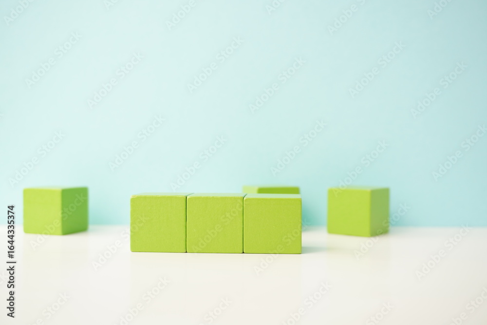 Abstract display of green building blocks in a neat arrangement, versatile wooden cubes on clean background for business, health and education concepts. Abstract display of green building blocks in a neat arrangement, versatile wooden cubes on clean background for business, health and education concepts.
