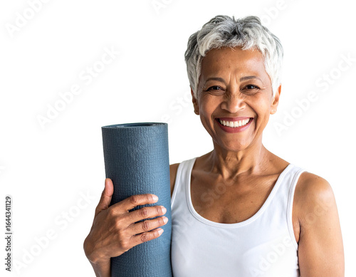Senior woman holding yoga mat smiling