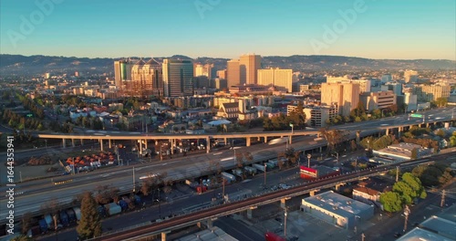 Timelapse of Oakland, California, USA, at sunrise. Cars travel on the highway below the city skyline, showcasing urban life and transportation.