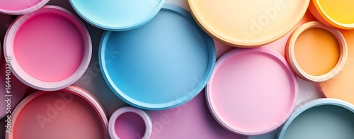 A vibrant abstract palette of colorful plastic caps, cups, and shiny glass balls creates a playful, bright circle against a white background