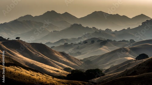 Rolling hills and distant mountains under a hazy light.