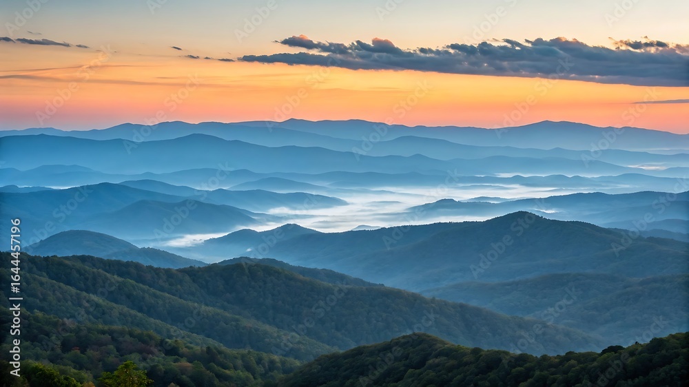Fototapeta premium Layered blue mountains misty sunrise landscape