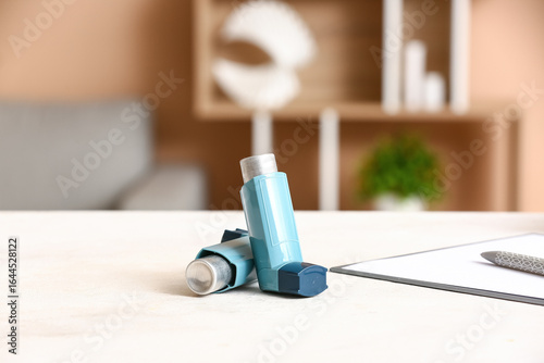 Asthma inhaler on table in ...