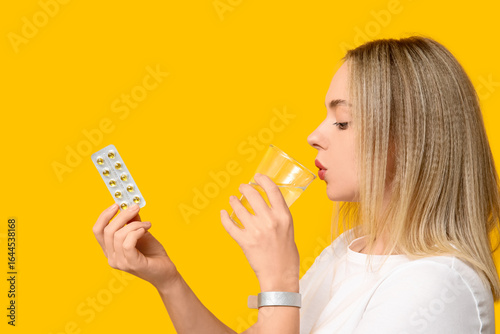 Young woman with vitamin A ...