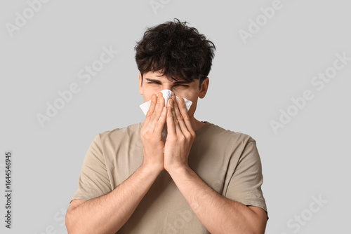 Young man with runny nose o...