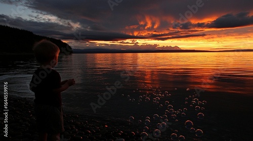 Child watching sunset bubbles on a beach