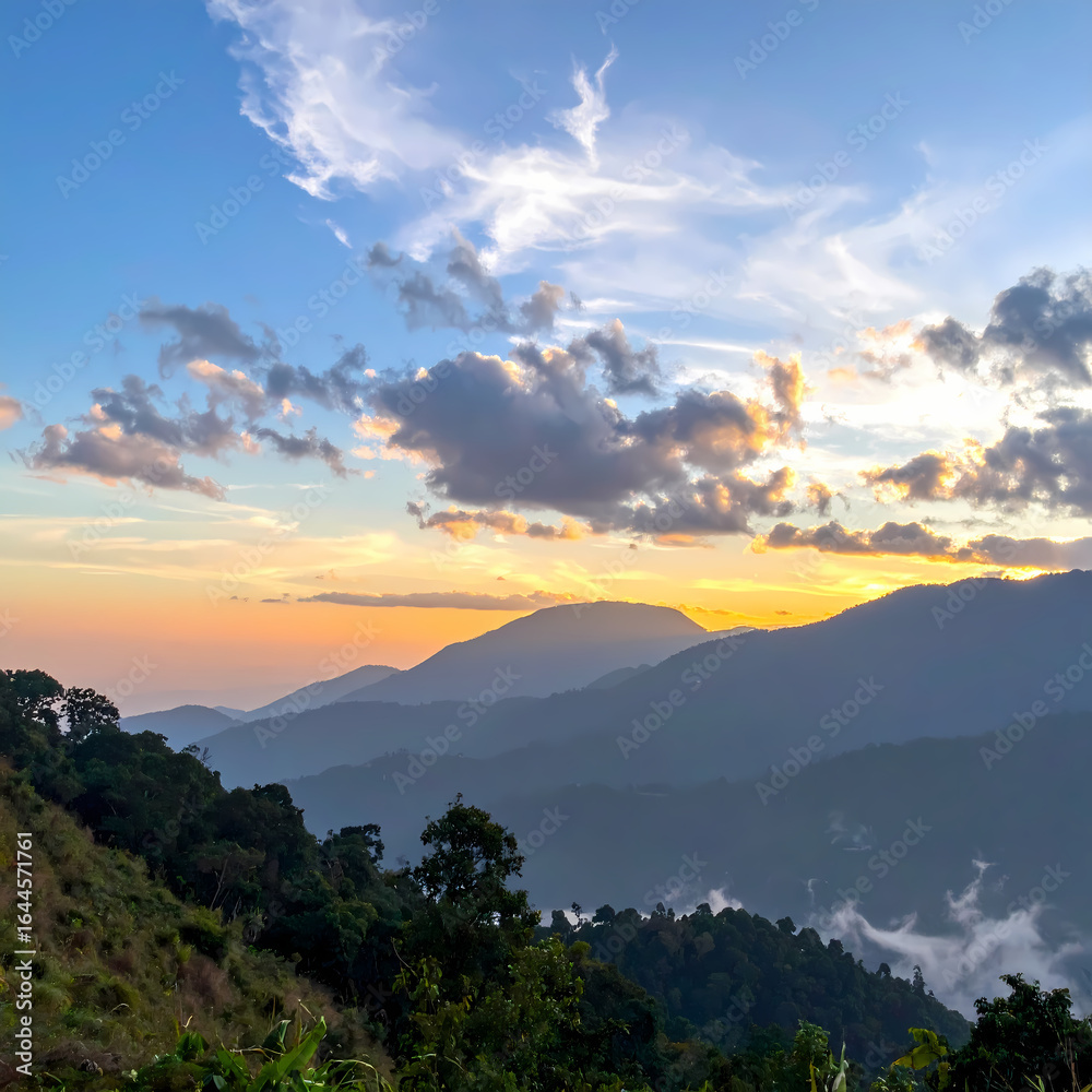 Obraz premium Sunset over mountain range landscape