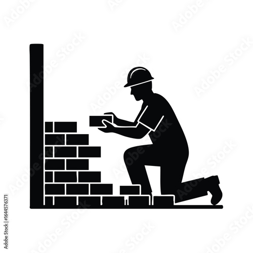 A silhouette depicts a construction worker kneeling, meticulously laying bricks to build a wall, showcasing the process of masonry in a structured environment.