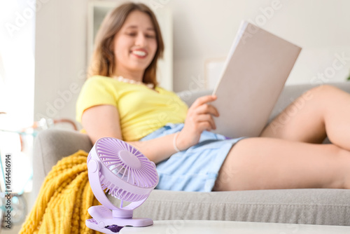 Mini fan on table against w...