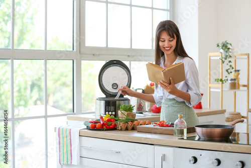 Young woman with recipe boo...