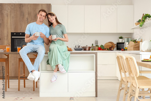 Young couple with cups of c...