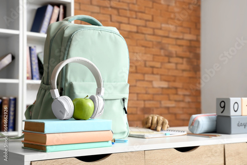 Headphones with apple, book...