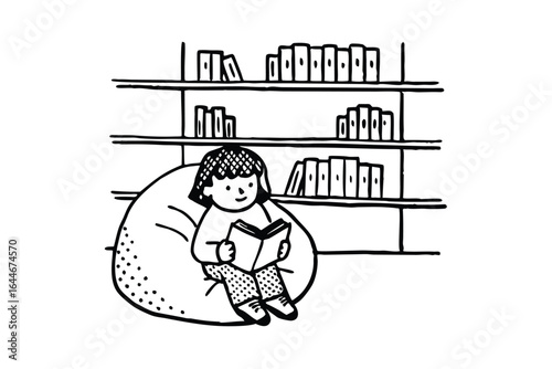 Person reading a book while sitting in a beanbag chair between two bookshelves