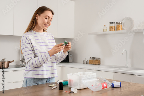 Young woman with pills and ...