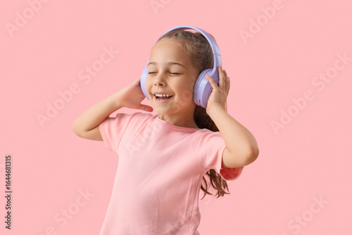 Cute little girl in headpho...