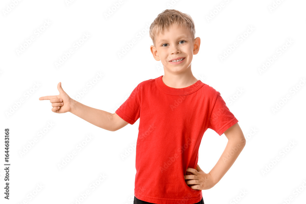 Cute little boy pointing at something on white background Cute little boy pointing at something on white background